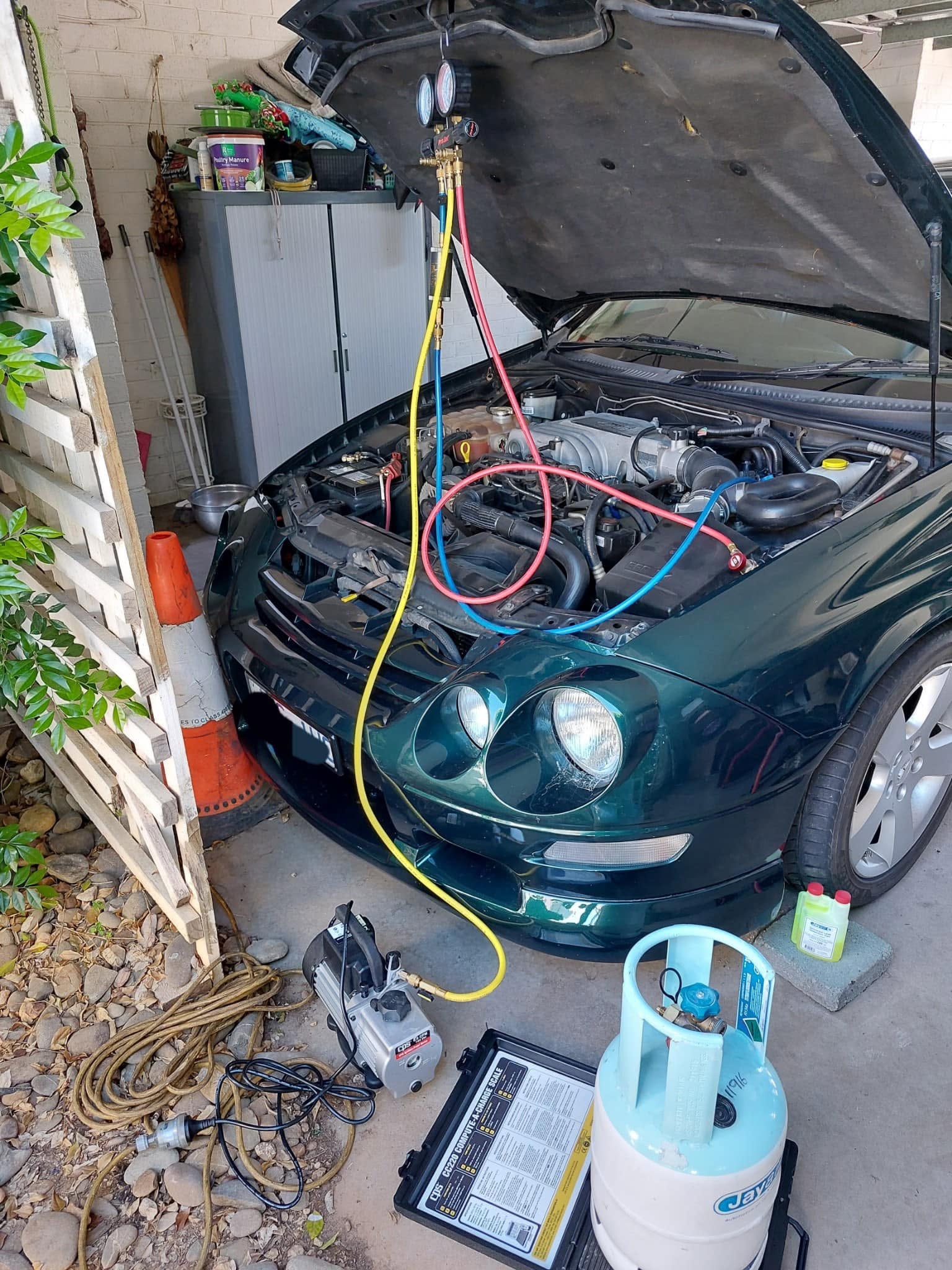 Green car AC regas in garage